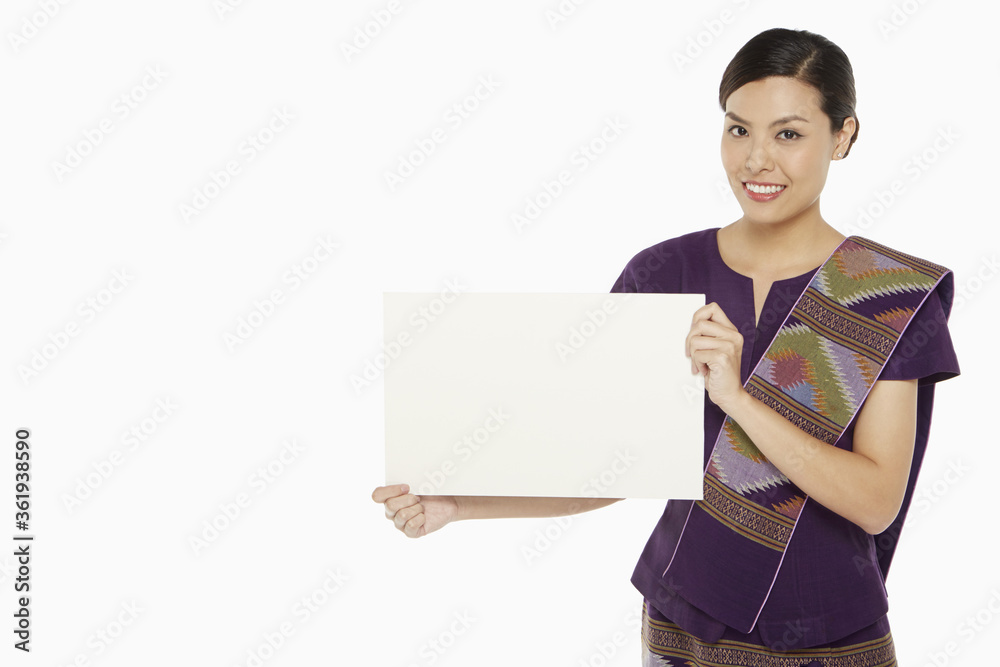 Woman in traditional clothing holding up a blank placard Woman in traditional clothing holding up a blank placard