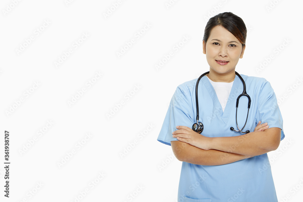 Medical personnel standing with arms crossed, smiling Medical personnel standing with arms crossed, smiling