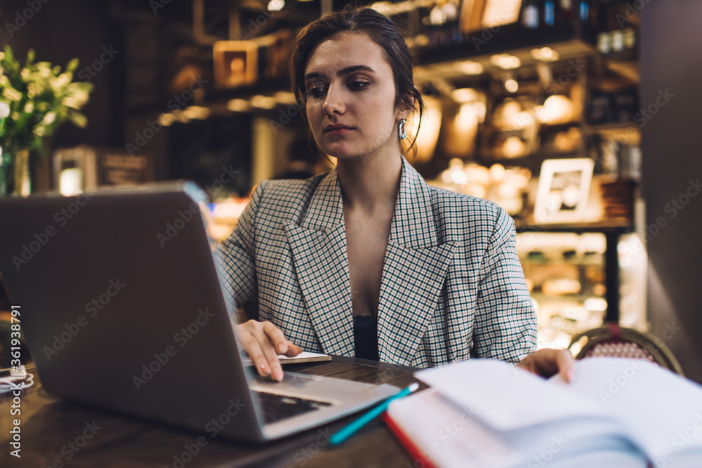 Tired woman using laptop in cafe