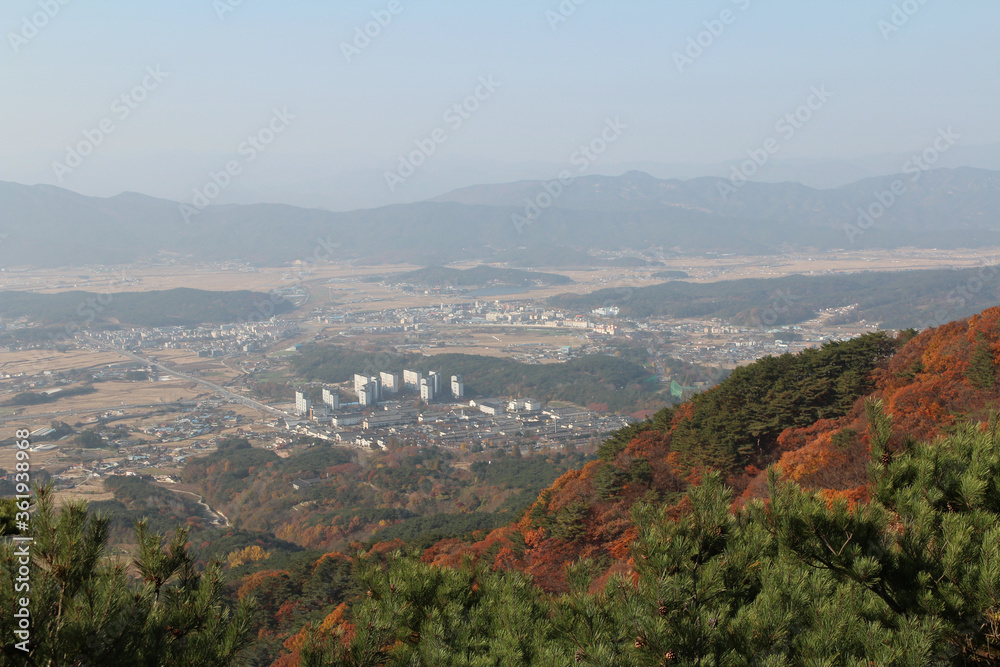 Gyeongju landscape with the buildings, mountains and paddy fields in autumn from Mt. Tohamsan, South Korea