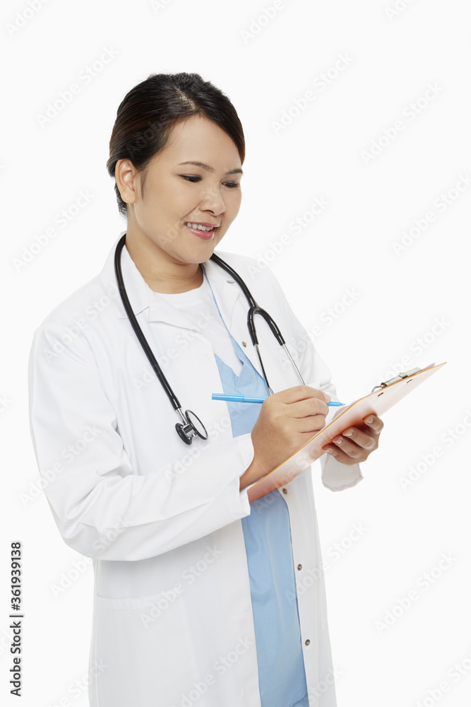 Medical personnel writing down notes on clip board Medical personnel writing down notes on clip board