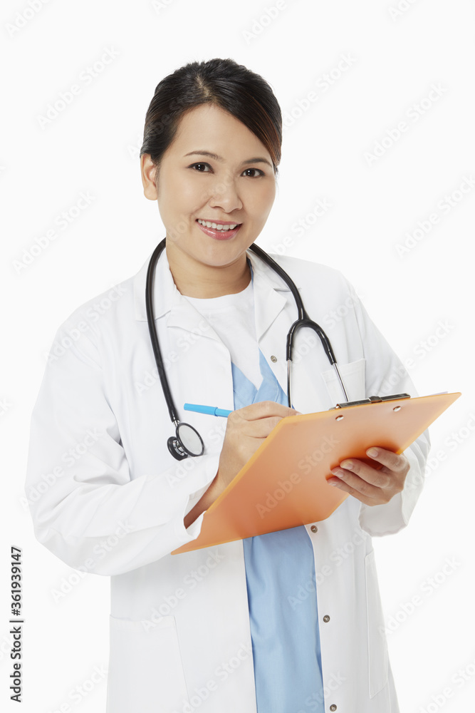Medical personnel writing down notes on clip board Medical personnel writing down notes on clip board