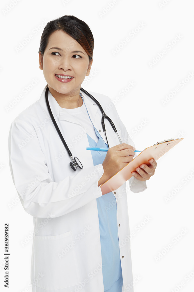 Medical personnel writing down notes on clip board Medical personnel writing down notes on clip board