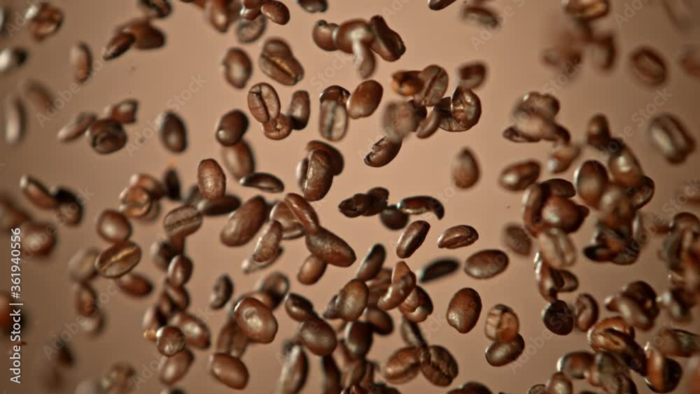 Super Slow Motion Shot of Crashing Coffee Beans on Brown Gradient Background at 1000fps. Super Slow Motion Shot of Crashing Coffee Beans on Brown Gradient Background at 1000fps.