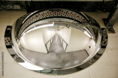 Photos Corridor inside a building with blind corners and a convex saConvex safety mirro