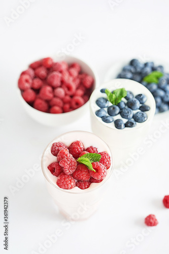 Yogurt cocktail and parfait. Natural detox. Liquid ice cream. Healthy food and breakfast. Good morning. Berry Milk Smoothie with blueberries, strawberries, raspberries. Fresh diet dessert. Summer card