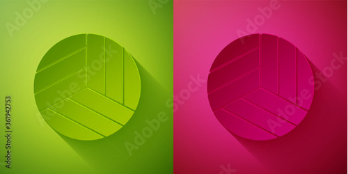 Paper cut Volleyball ball icon isolated on green and pink background. Sport equipment. Paper art style. Vector Illustration.
