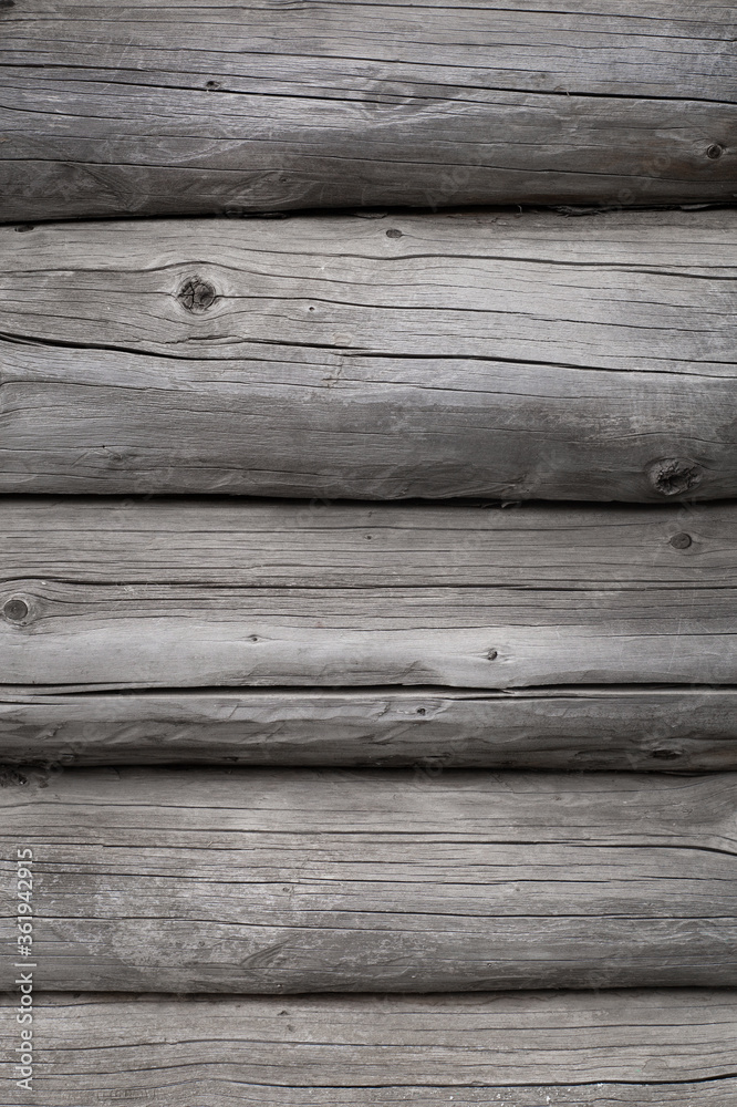 Wood texture. Old grey logs with knots. 