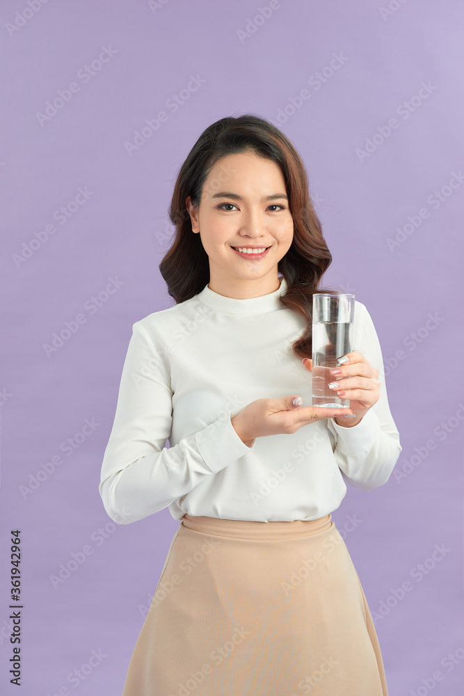 Young smiling woman holding water glass. Young smiling woman holding water glass.