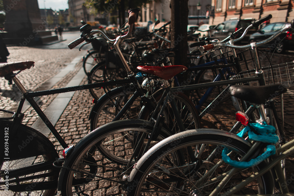 Selective focus of bicycles on walkway on urban street in Copenhagen, Denmark