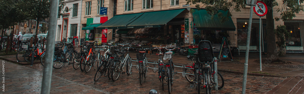 Fototapeta Panoramic crop of row of bicycles on urban street in Copenhagen, Denmark