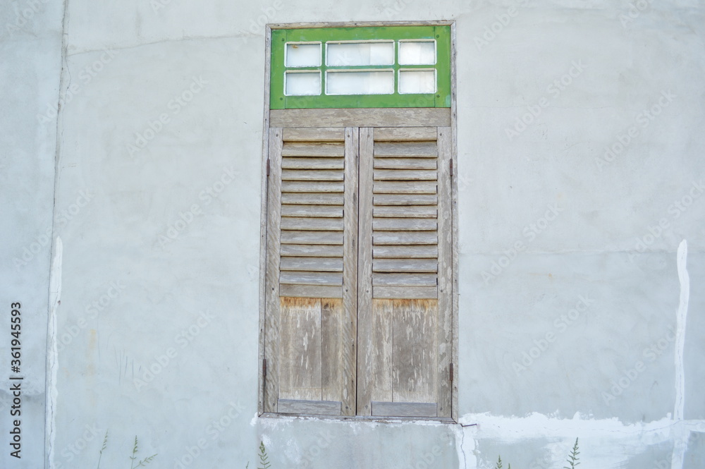 photos of cement walls and old wooden doors
