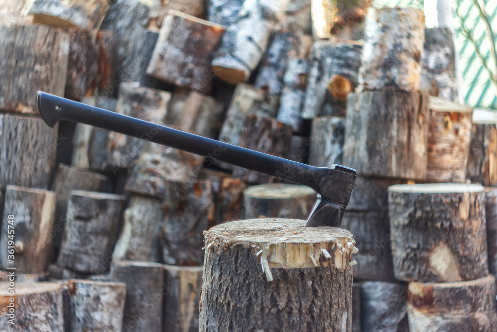 Axe stuck in a tree stump on a beautiful landscape. Firewood concept. Chopping a tree log for wood fire. No electricity concept. Preparing food old fashion way. Wood fire for a cold night. Axe stuck in a tree stump on a beautiful landscape. Firewood concept. Chopping a tree log for wood fire. No electricity concept. Preparing food old fashion way. Wood fire for a cold night.