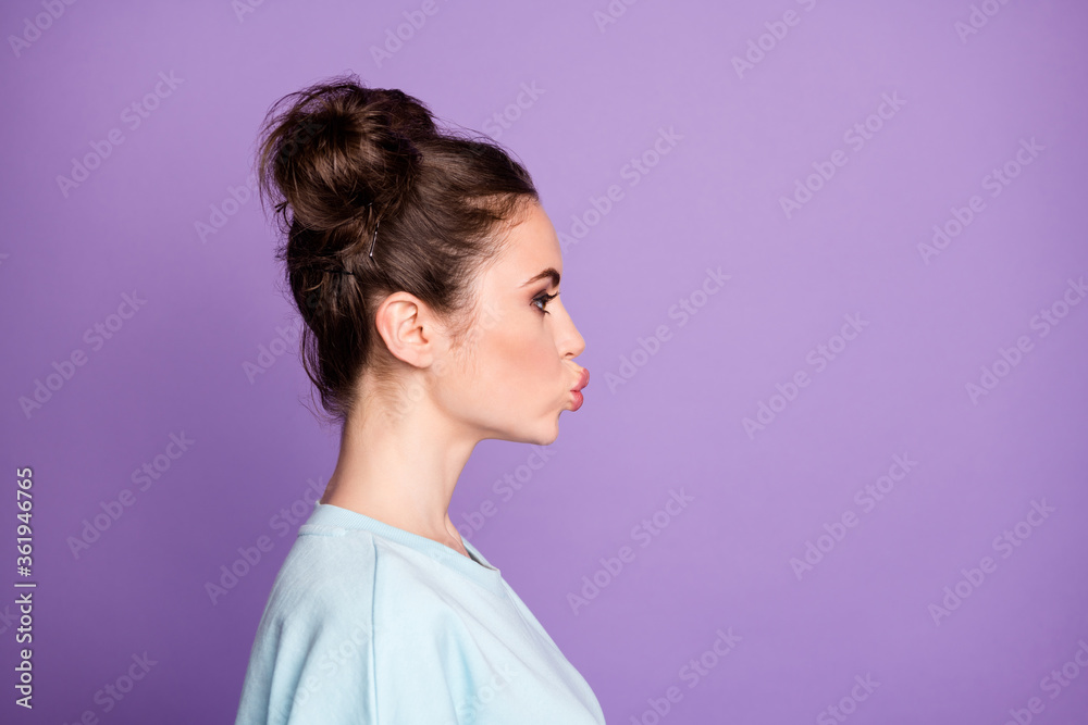 Profile side photo of gorgeous pretty girl youth send air kiss her boyfriend wear casual style clothes isolated over violet color background Profile side photo of gorgeous pretty girl youth send air kiss her boyfriend wear casual style clothes isolated over violet color background