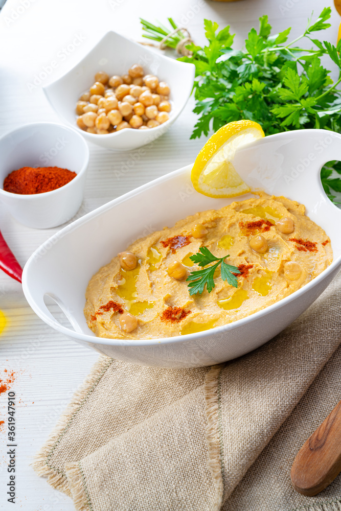 hummus paste with lemon and chilli on white background hummus paste with lemon and chilli on white background