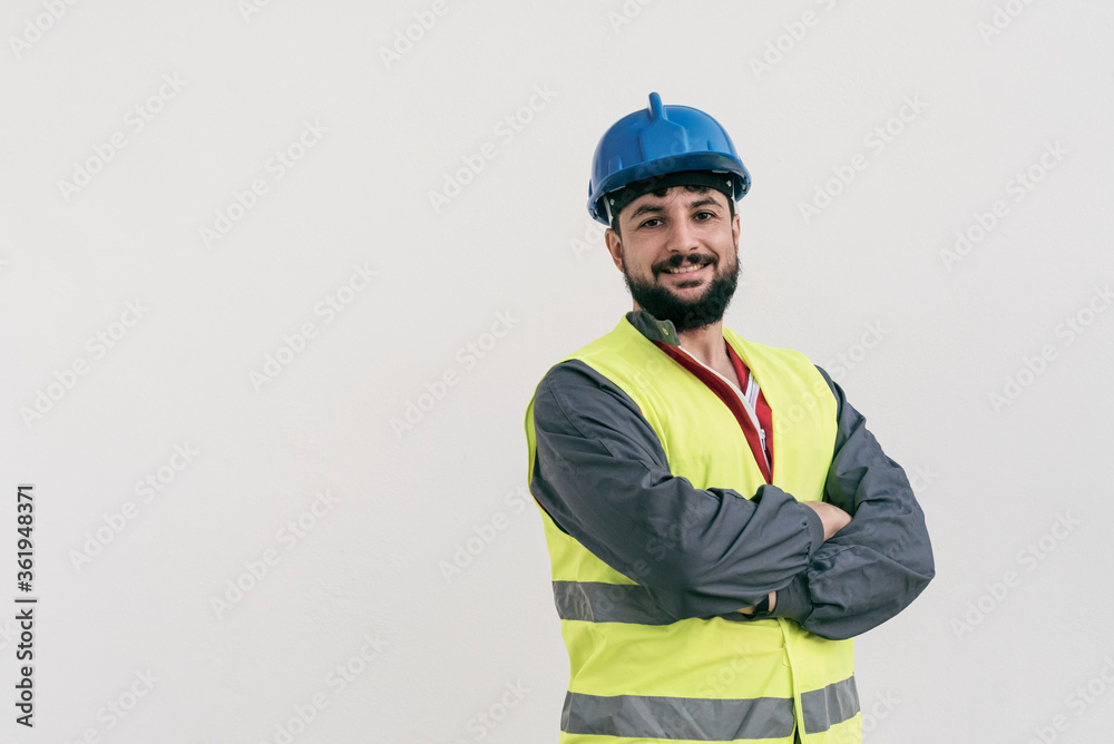 Fototapeta premium Construction worker portrait on white wall posing