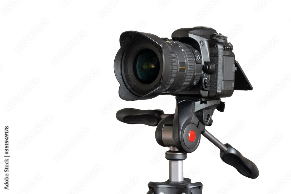 Digital camera with lens hood on tripod closeup isolated on white background with copy space