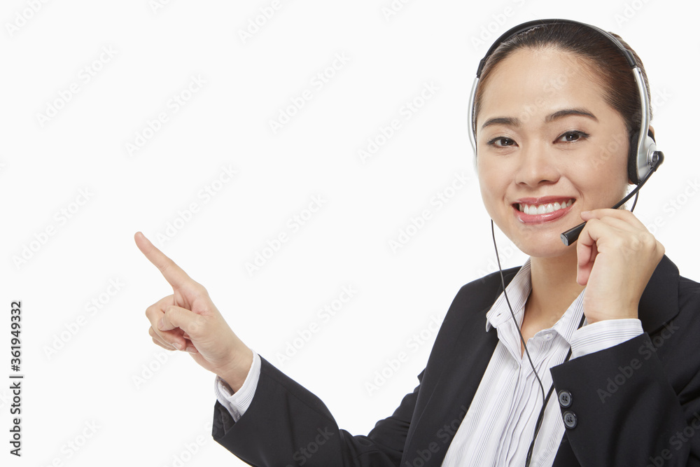 Businesswoman with headset pointing to the right Businesswoman with headset pointing to the right