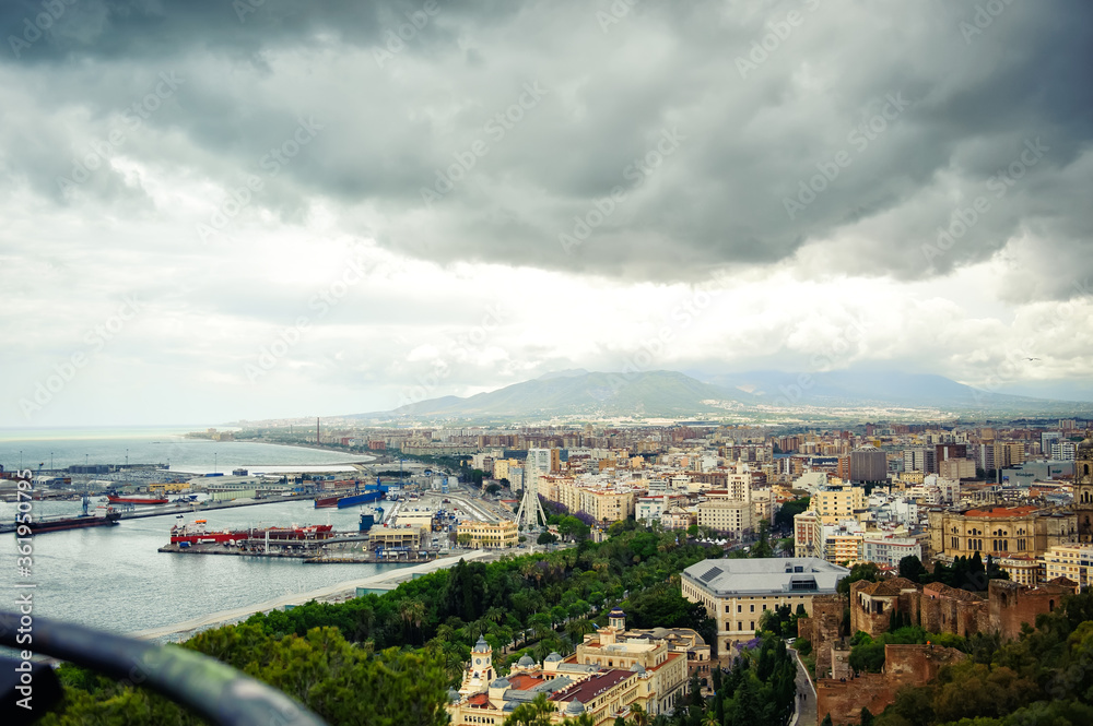 Aerial panoramic view of cityscape and harbour of Spanish city of Malaga, Costa del Sol, Spain, in spring cloudy day. Travel tourism destination