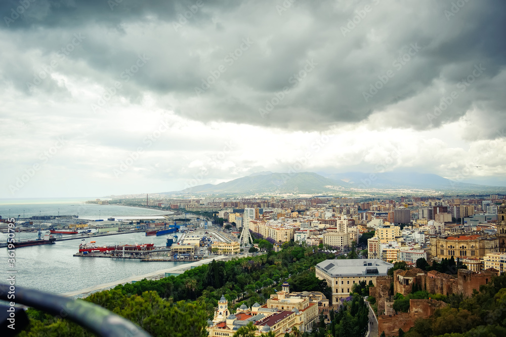 Fototapeta premium Aerial panoramic view of cityscape and harbour of Spanish city of Malaga, Costa del Sol, Spain, in spring cloudy day. Travel tourism destination