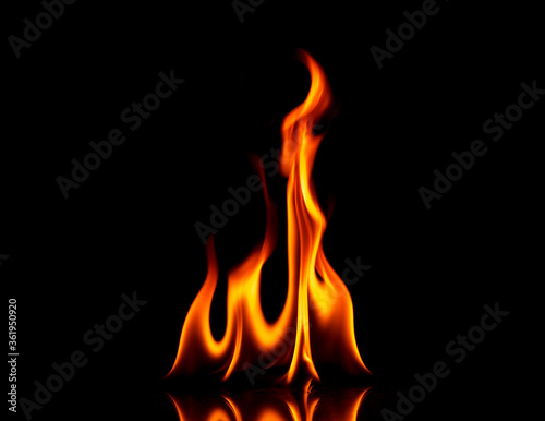 Fire with reflection on a dark background.