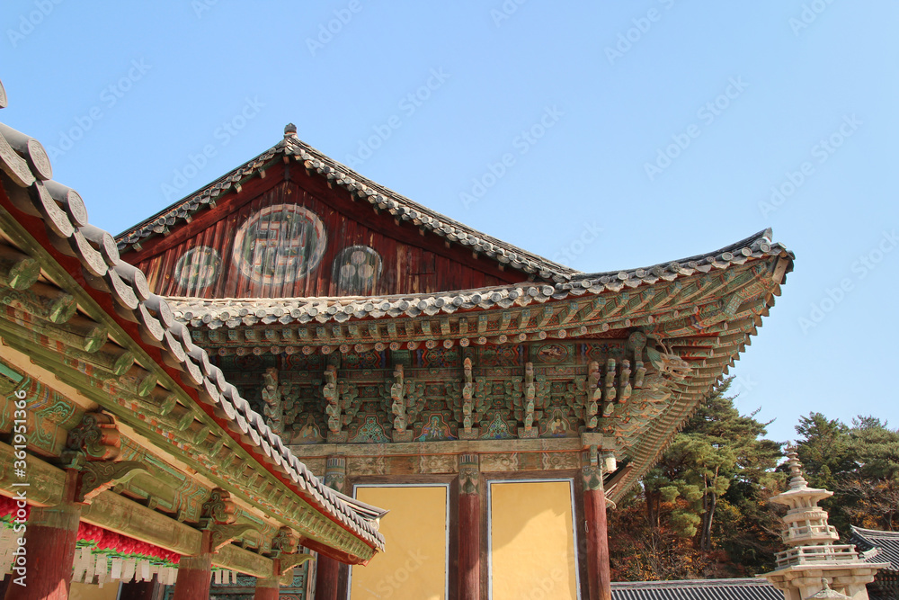 Korean traditional architecture detail of eaves with Buddha images at Bulguksa Temple in Gyeongju, South Korea