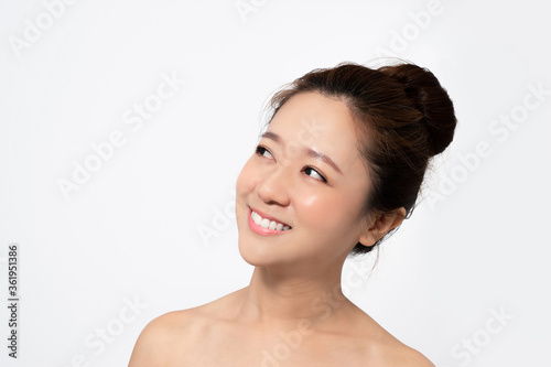 Face of a beautiful asian woman on a white background in a studio.