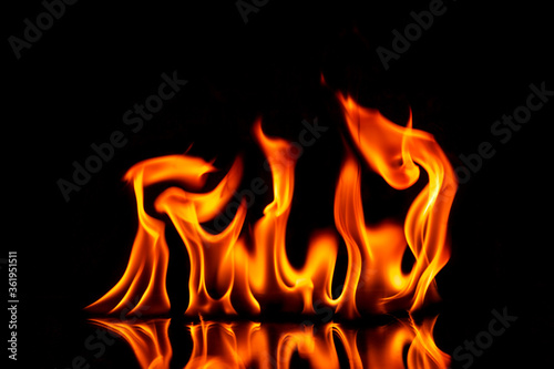 Fire with reflection on a dark background.
