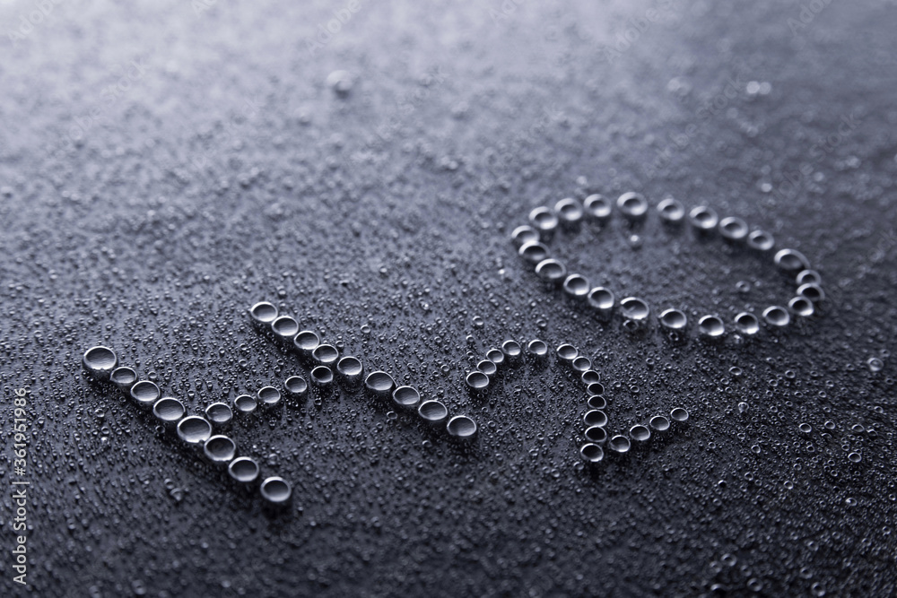 Water droplets making a H2O on a surface Water droplets making a H2O on a surface