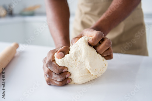 Canvas Print Cropped close-up view of nice hands guy confectioner making fresh bread pie pide