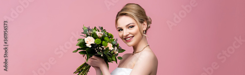 panoramic orientation of bride holding wedding flowers isolated on pink