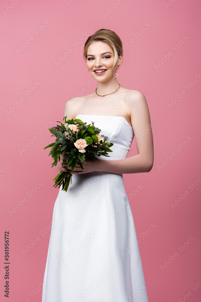happy girl in white wedding dress holding flowers isolated on pink happy girl in white wedding dress holding flowers isolated on pink