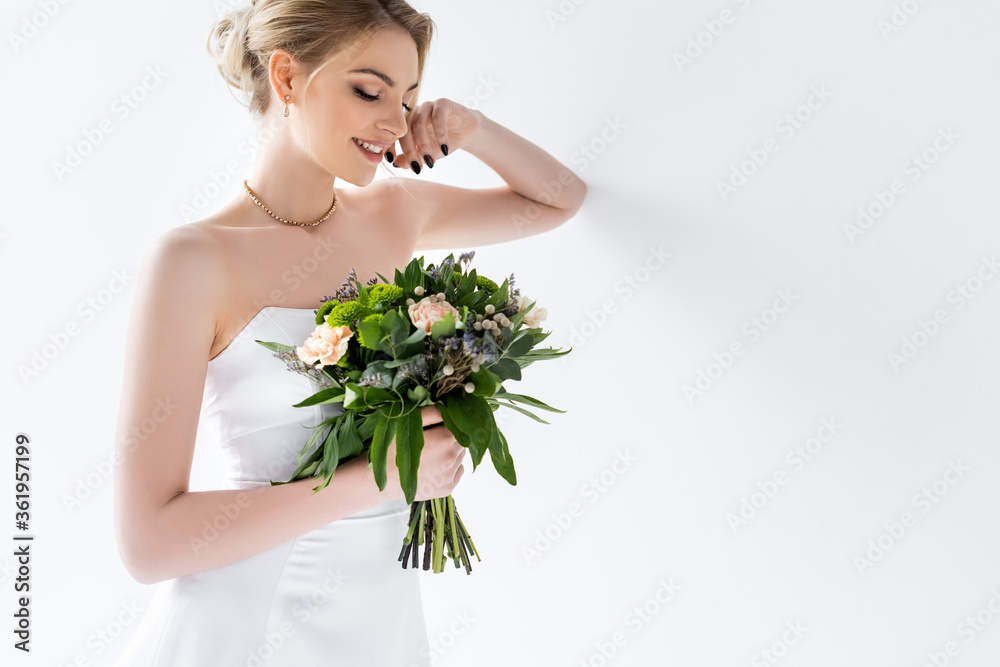 happy young bride in elegant wedding dress holding flowers on white happy young bride in elegant wedding dress holding flowers on white