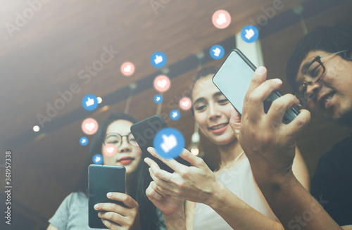 young people using smartphone in cafe photo