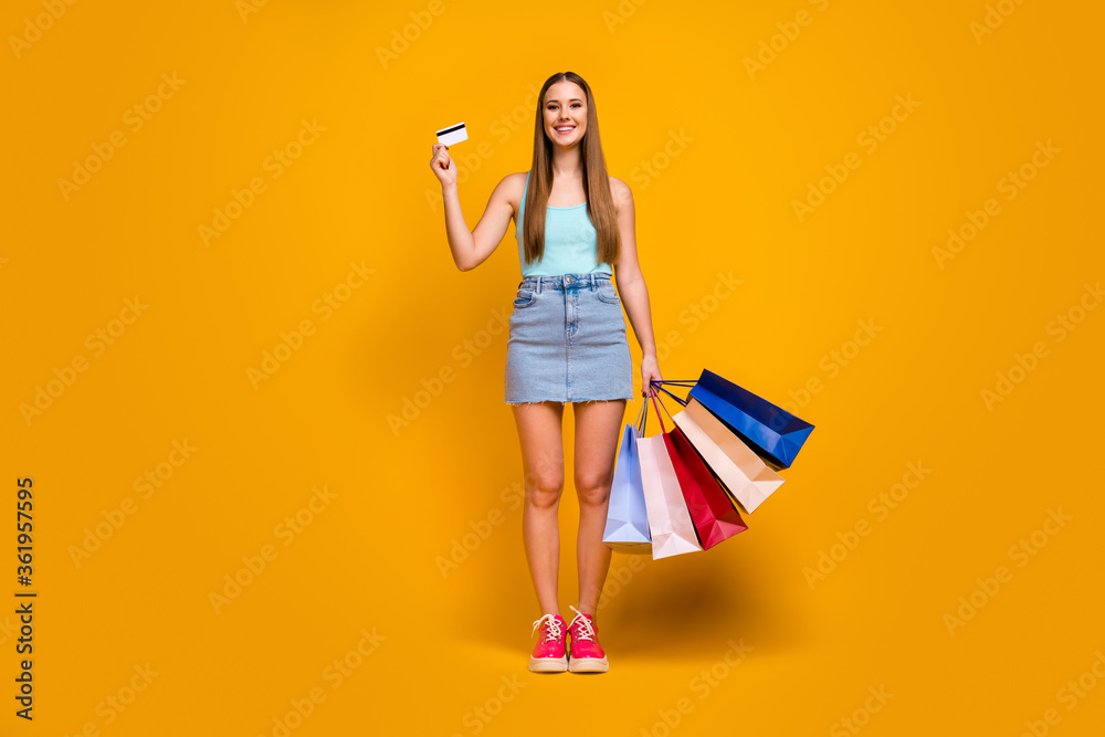 Full length body size view of her she nice attractive lovely cheerful cheery straight-haired girl holding in hands new things bank card isolated on bright vivid shine vibrant yellow color background Full length body size view of her she nice attractive lovely cheerful cheery straight-haired girl holding in hands new things bank card isolated on bright vivid shine vibrant yellow color background