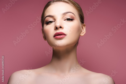 naked young woman with eye shadow and lipstick on pink