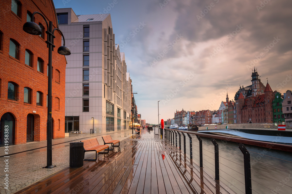 Old town in Gdansk over the Motlawa river at rainy sunset, Poland.