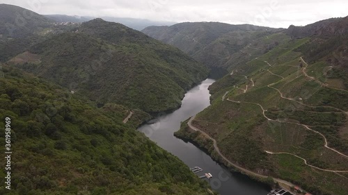 Aerial shot of a dron going across a tent facing a stunning canyon with a river in the middle of it