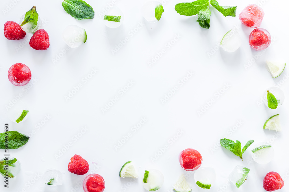 Berries and mint in ice cubes top view frame copy space