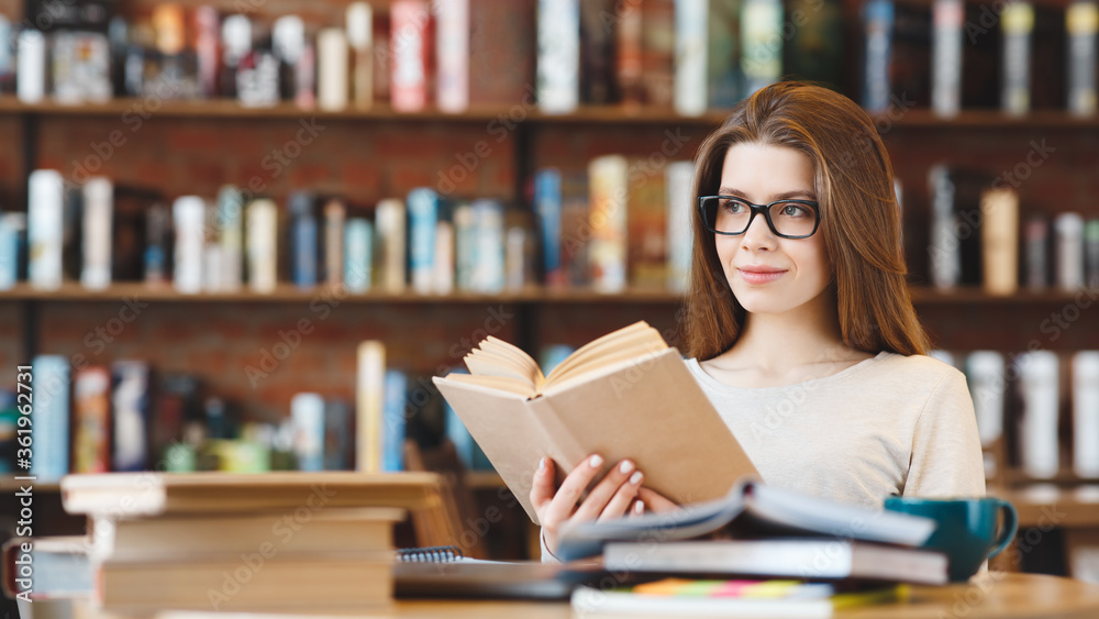 Attractive young girl student with lots of books in a cafe Attractive young girl student with lots of books in a cafe