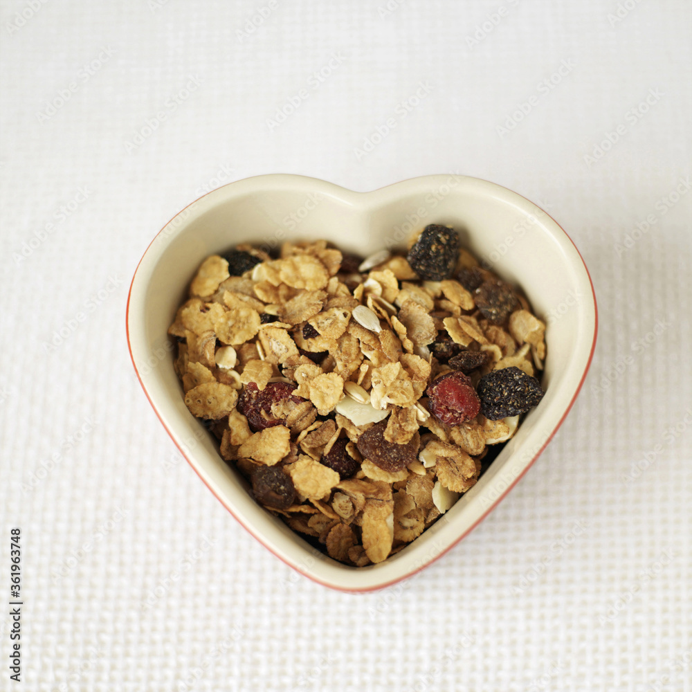 Fototapeta premium Muesli in heart bowl