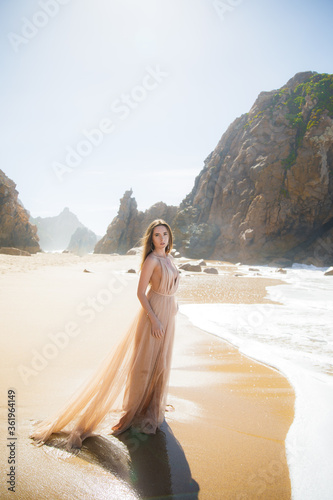 Beautiful girl walking on the beach at sunset  freedom concept