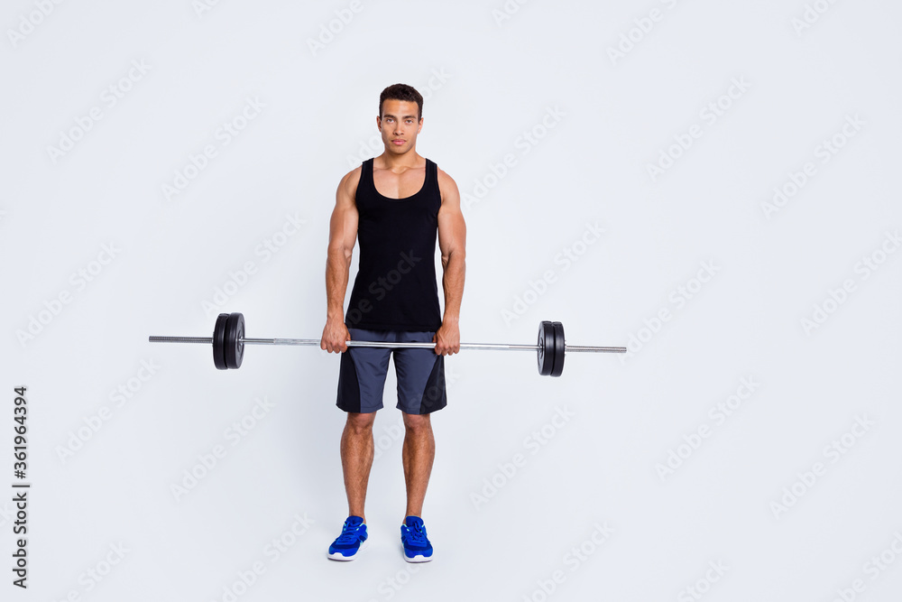 Full length body size view of his he nice attractive content sportive serious guy doing exercise lifting barbell body sculpt pilates progress isolated over light gray pastel color background Full length body size view of his he nice attractive content sportive serious guy doing exercise lifting barbell body sculpt pilates progress isolated over light gray pastel color background