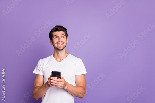 Portrait of his he nice attractive cheerful cheery glad dreamy creative guy using digital device creating smm like isolated over bright vivid shine vibrant violet lilac purple color background © deagreez
