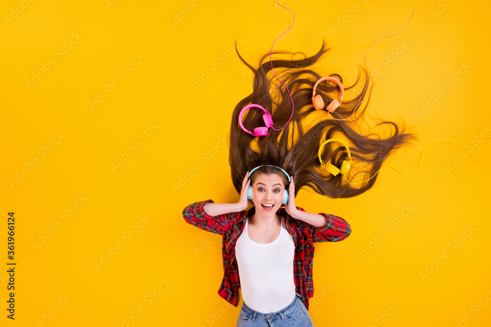 Top view above high angle flat lay flatlay lie concept of nice pretty funky glad cheerful girl listening rock hit composition having fun isolated bright vivid shine vibrant yellow color background Top view above high angle flat lay flatlay lie concept of nice pretty funky glad cheerful girl listening rock hit composition having fun isolated bright vivid shine vibrant yellow color background