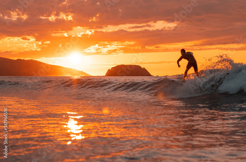 Fototapeta Naklejka Na Ścianę i Meble -  Surfing silhouette at sunset.