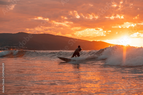 Surfing silhouette at sunset.