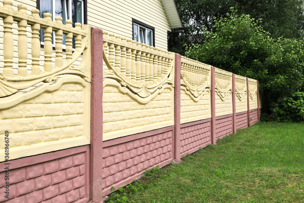 Decorative concrete fence made of blocks close-up, in a receding  perspective. Green plants on the backdrop on a summer day Stock Photo |  Adobe Stock