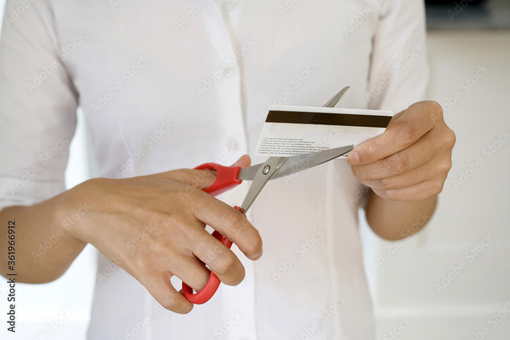 Businesswoman cutting credit card