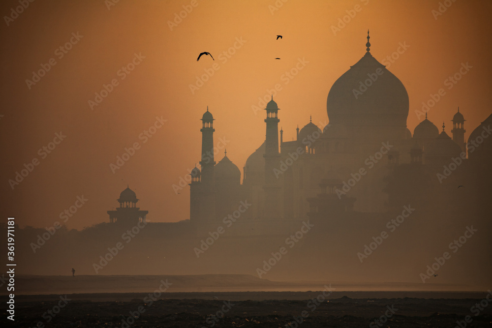 Silhouette of the Taj Mahal seen from the banks of Yamuna River in Agra